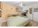 Cozy bedroom featuring a ceiling fan, tile flooring, and a colorful patterned quilt on the bed at 1094 Henry Balch Dr, Orlando, FL 32810