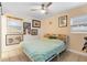 Cozy bedroom featuring a ceiling fan, natural light, and stylishly framed wall decor at 1094 Henry Balch Dr, Orlando, FL 32810