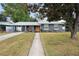 Charming one-story home with well-maintained lawn and a bright orange front door at 1094 Henry Balch Dr, Orlando, FL 32810