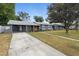 Charming single-story home with a long driveway and well-manicured front lawn at 1094 Henry Balch Dr, Orlando, FL 32810