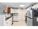 Bright kitchen featuring white cabinets, tile flooring, modern appliances, and natural lighting at 1094 Henry Balch Dr, Orlando, FL 32810