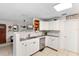Bright kitchen featuring white cabinets, tile flooring, modern appliances, and breakfast bar at 1094 Henry Balch Dr, Orlando, FL 32810