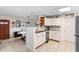 Bright kitchen featuring white cabinets, tile flooring, modern appliances, and breakfast bar at 1094 Henry Balch Dr, Orlando, FL 32810