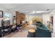 Spacious living room with exposed beams, brick accent wall, and comfortable seating area at 1094 Henry Balch Dr, Orlando, FL 32810