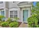 Welcoming front entrance with vibrant, light teal-colored door and well-maintained landscaping at 1150 Vineland Pl, Lake Mary, FL 32746