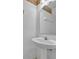 Clean half bathroom featuring a pedestal sink and a large mirror at 1150 Vineland Pl, Lake Mary, FL 32746