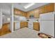 Functional kitchen with white appliances, wooden cabinets, and tile flooring at 1150 Vineland Pl, Lake Mary, FL 32746