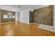Large living room showcasing hardwood floors, a decorative mirror, and elegant lighting at 1150 Vineland Pl, Lake Mary, FL 32746