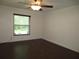 A bedroom featuring wood flooring and natural light from the window at 11540 Sandy Hill Dr, Orlando, FL 32821
