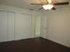 A bedroom featuring wood floors, neutral walls, and closet storage space at 11540 Sandy Hill Dr, Orlando, FL 32821