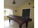 Spacious game room with billiard table and a window bringing in natural light at 11540 Sandy Hill Dr, Orlando, FL 32821