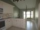 Bright kitchen featuring white cabinets, a breakfast bar with seating, and a bay window at 11540 Sandy Hill Dr, Orlando, FL 32821