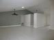 Open living room area with neutral tile flooring, high ceilings, and modern ceiling fan at 11540 Sandy Hill Dr, Orlando, FL 32821