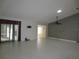 Spacious living room with large sliding doors and tile flooring for easy maintenance at 11540 Sandy Hill Dr, Orlando, FL 32821