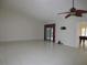 An expansive living room featuring light tile floors and sliding glass doors at 11540 Sandy Hill Dr, Orlando, FL 32821