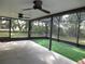 Large screened-in lanai with ceiling fans, providing a comfortable space for outdoor enjoyment and dining at 11540 Sandy Hill Dr, Orlando, FL 32821