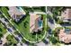 Aerial view of the house surrounded by lush landscaping, with backyard pool, paver driveway and tile roof at 11706 Waterstone Loop Dr, Windermere, FL 34786