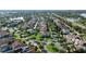 Aerial view of a community featuring numerous houses, lush trees, landscaping, and street views at 11706 Waterstone Loop Dr, Windermere, FL 34786