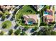 Overhead view of a house with a pool surrounded by green lawns, mature trees, and paver driveway at 11706 Waterstone Loop Dr, Windermere, FL 34786