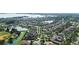 Expansive aerial view of a Primary planned community showcasing well-maintained homes, lush landscaping and numerous waterways at 11706 Waterstone Loop Dr, Windermere, FL 34786
