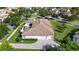 Aerial view of a sprawling home with manicured lawns, pool, lush greenery, and a paver driveway at 11706 Waterstone Loop Dr, Windermere, FL 34786