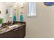 Bathroom featuring a granite countertop, a modern sink, and a framed mirror, creating a luxurious space at 11706 Waterstone Loop Dr, Windermere, FL 34786