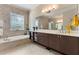 Spacious bathroom with a soaking tub, double vanity, and tile flooring at 11706 Waterstone Loop Dr, Windermere, FL 34786