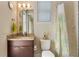 Bright bathroom featuring granite vanity, neutral walls, and a bathtub with shower and patterned shower curtain at 11706 Waterstone Loop Dr, Windermere, FL 34786