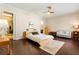 Comfortable bedroom with a ceiling fan, wood floors, and natural light at 11706 Waterstone Loop Dr, Windermere, FL 34786