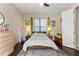 Cozy bedroom with neutral walls, hardwood floors, and light green accents at 11706 Waterstone Loop Dr, Windermere, FL 34786