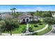 Beautiful front exterior with lush landscaping, green grass, walkway and elegant entrance of a home at 11706 Waterstone Loop Dr, Windermere, FL 34786