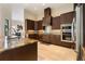 Modern kitchen showcasing dark wood cabinetry, granite countertops, stainless appliances, and tile backsplash at 11706 Waterstone Loop Dr, Windermere, FL 34786