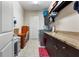 Spacious laundry room with granite counters, cabinets, sink, tile floors, plus washer, dryer, desk and storage at 11706 Waterstone Loop Dr, Windermere, FL 34786