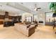 Open-concept living space featuring a kitchen, dining area, and a living room with a fireplace and stone accent wall at 11706 Waterstone Loop Dr, Windermere, FL 34786