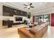 A bright living room with a sectional sofa, modern built-ins, large windows and sliding glass doors to the outdoor space at 11706 Waterstone Loop Dr, Windermere, FL 34786