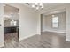 Bright dining area with chandelier lighting and wood-style tile flooring at 11807 Charades St, Orlando, FL 32832