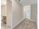 Upstairs hallway with carpeted floors, closet, and view of a bathroom at 11807 Charades St, Orlando, FL 32832