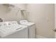 A well-lit laundry room equipped with a washer and dryer at 11807 Charades St, Orlando, FL 32832