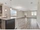 Open-concept living room with stainless steel appliances and ample natural light at 11807 Charades St, Orlando, FL 32832