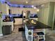 Contemporary kitchen featuring white cabinets, a spacious island, and modern lighting at 1203 Monterey Dr, Eustis, FL 32726