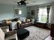 Comfortable living room featuring neutral colors, a plush rug, and natural light from the window at 1203 Monterey Dr, Eustis, FL 32726