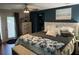 Serene bedroom with dark blue accent wall, plush bedding, and access to a private balcony at 1203 Monterey Dr, Eustis, FL 32726