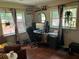 Bright home office with dual windows, comfortable seating, and plenty of natural light at 1203 Monterey Dr, Eustis, FL 32726