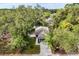 Aerial view of the home featuring mature trees, a driveway, and grass at 1203 W 16Th St, Sanford, FL 32771