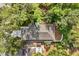 Aerial view of the roof, the driveway, mature trees, and a backyard with a fence at 1203 W 16Th St, Sanford, FL 32771