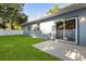 Backyard view showing the blue house, white fence, green grass, and sliding glass door at 1203 W 16Th St, Sanford, FL 32771