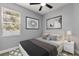 Cozy bedroom features neutral walls, ceiling fan, natural light, and decorative wall art at 1203 W 16Th St, Sanford, FL 32771