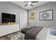 Bright bedroom featuring modern flooring, a TV, dresser, and bright, natural light at 1203 W 16Th St, Sanford, FL 32771