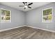 Bedroom featuring neutral walls, hardwood floors, two bright windows, and ample outlets at 1203 W 16Th St, Sanford, FL 32771