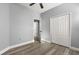 Bedroom featuring neutral walls, ceiling fan, hardwood floors, and closet storage at 1203 W 16Th St, Sanford, FL 32771